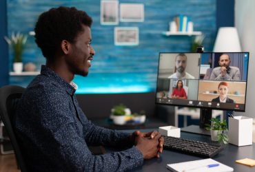 Business student having online videocall meeting conference Business student having online videocall meeting conference with remote university team discussing marketing ideas in living room. Videoconference telework call on computer computer screen
